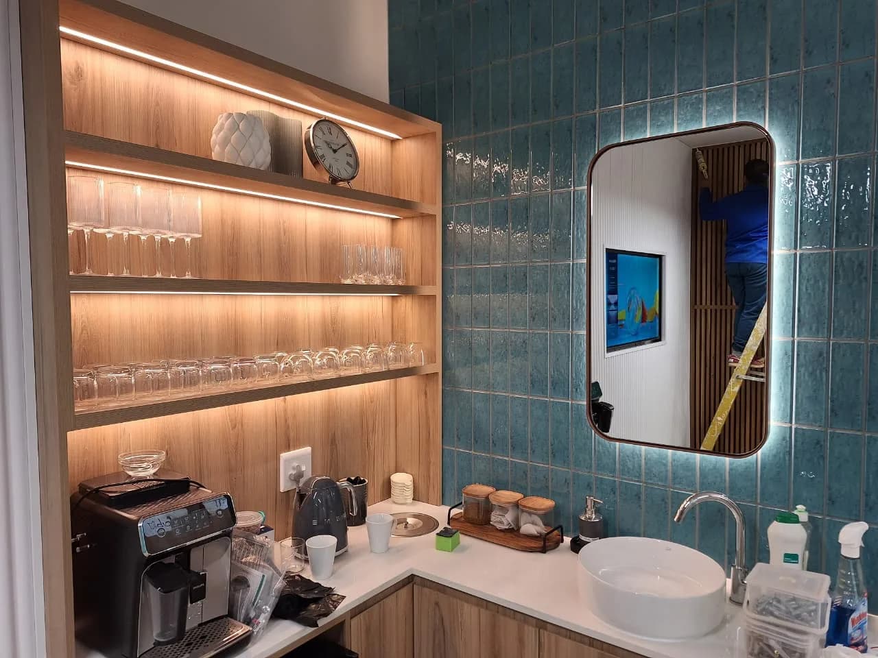 Backlit mirror and tiled feature wall lighting in a commercial fit-out